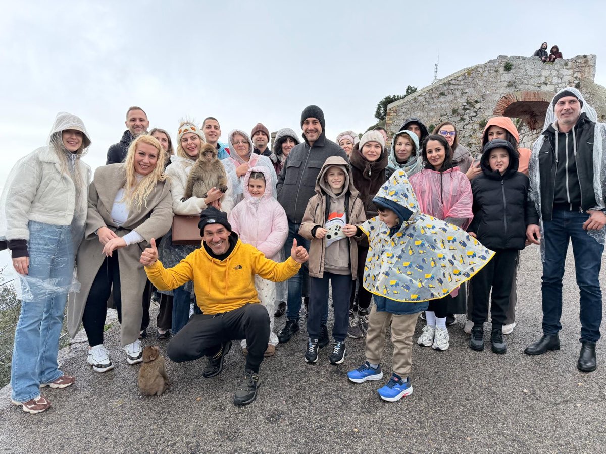A large tour group with Jason on the Upper Rock, with Barbary macaques joining the photo